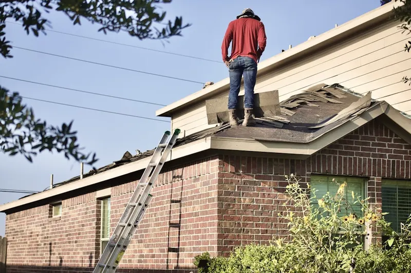 Professional roofer working on a residential roof in Yalaha